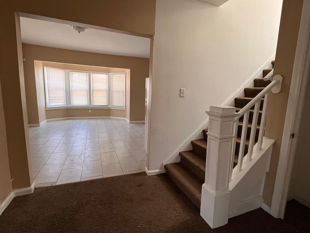 2711 Burlingame St, Detroit, MI 48206 - stairs with baseboards, tile patterned floors, and carpet flooring
