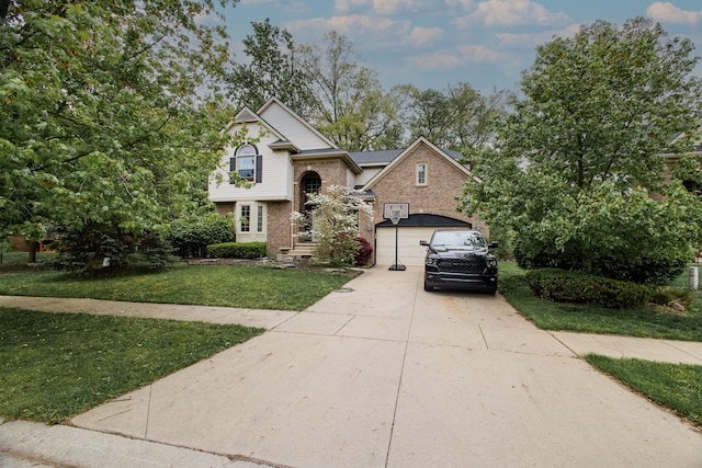 1418 Trailside Blvd, Wixom, MI 48393 - view of front of house featuring concrete driveway, a front yard, and brick siding