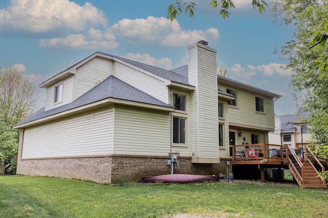 1418 Trailside Blvd, Wixom, MI 48393 - rear view of property featuring a yard, a wooden deck, a chimney, and brick siding