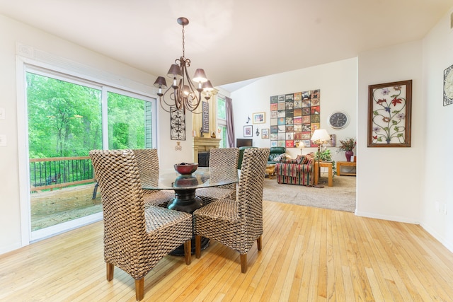 1418 Trailside Blvd, Wixom, MI 48393 - dining room with a chandelier, light wood-type flooring, and baseboards