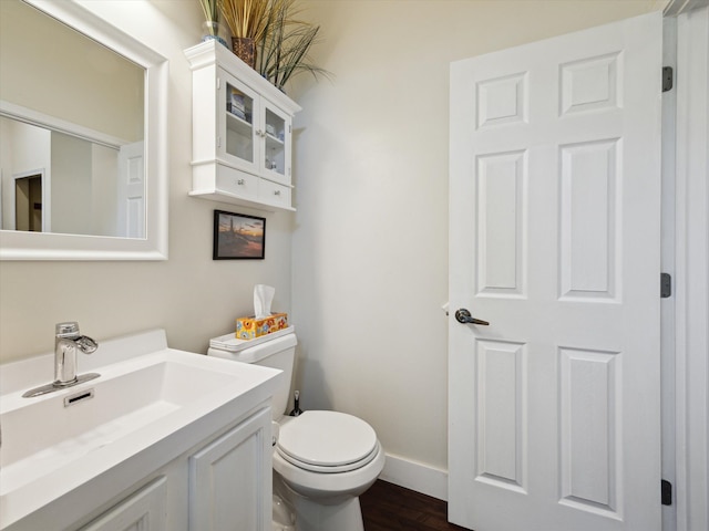 230 Atlantis Cir, Oxford, MI 48371 - bathroom with toilet, wood finished floors, vanity, and baseboards