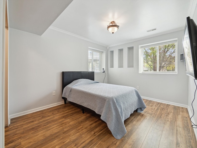 230 Atlantis Cir, Oxford, MI 48371 - bedroom with multiple windows, ornamental molding, baseboards, and wood finished floors