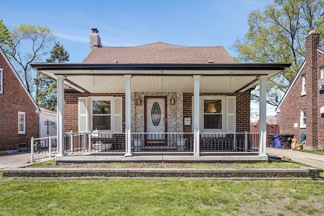 19985 Charest St, Detroit, MI 48234 - bungalow-style home featuring covered porch, brick siding, a shingled roof, and a chimney