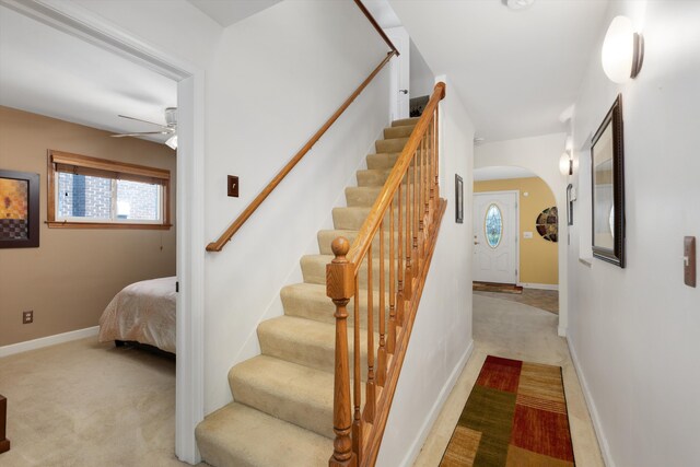 19985 Charest St, Detroit, MI 48234 - stairway with arched walkways, ceiling fan, carpet, and baseboards