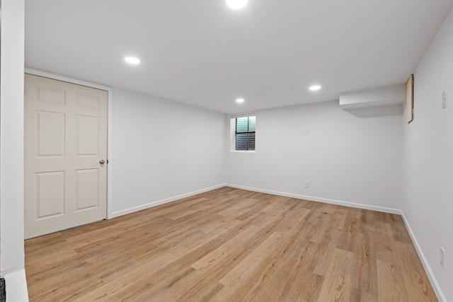 basement featuring light wood finished floors, recessed lighting, and baseboards