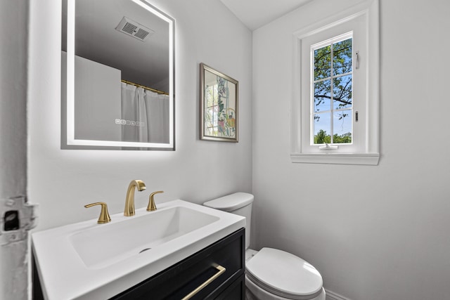bathroom featuring toilet and vanity