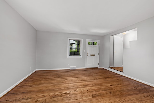 foyer entrance featuring baseboards and wood finished floors