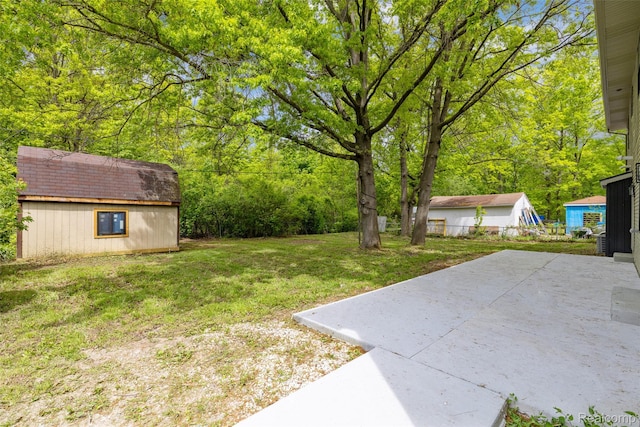 7598 Lake Park Rd, Ira, MI 48023 - view of green lawn featuring an outdoor structure and a patio area