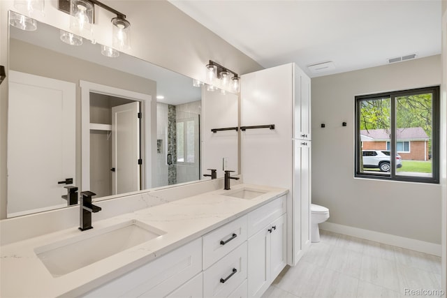 7598 Lake Park Rd, Ira, MI 48023 - full bath featuring double vanity, toilet, a stall shower, baseboards, and marble finish floors