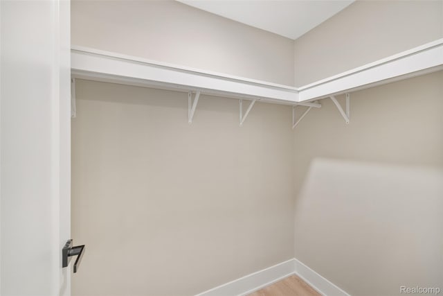 7598 Lake Park Rd, Ira, MI 48023 - spacious closet featuring light wood-type flooring