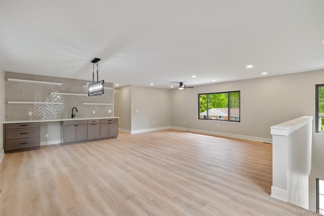 7598 Lake Park Rd, Ira, MI 48023 - unfurnished living room featuring a sink, light wood-type flooring, recessed lighting, and baseboards