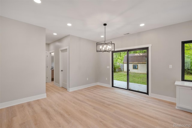 7598 Lake Park Rd, Ira, MI 48023 - unfurnished dining area featuring a chandelier, healthy amount of natural light, light wood-style floors, baseboards, and recessed lighting