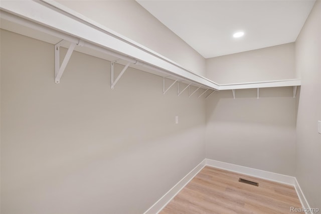 7598 Lake Park Rd, Ira, MI 48023 - walk in closet featuring light wood-type flooring
