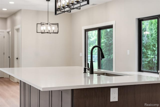 7598 Lake Park Rd, Ira, MI 48023 - kitchen with a sink, a chandelier, decorative light fixtures, recessed lighting, and a center island with sink