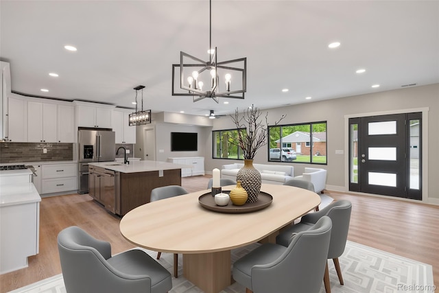 7598 Lake Park Rd, Ira, MI 48023 - dining space with a chandelier, light wood finished floors, recessed lighting, and baseboards
