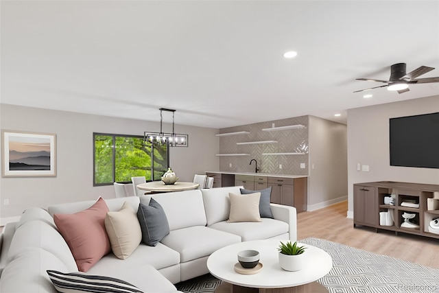 7598 Lake Park Rd, Ira, MI 48023 - living room with light wood-style flooring, a ceiling fan, recessed lighting, a chandelier, and baseboards