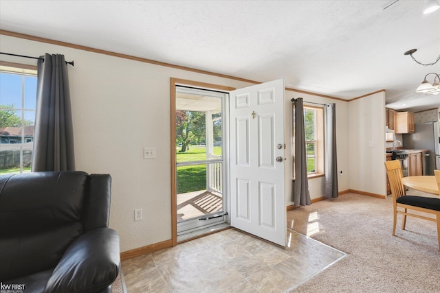 foyer featuring baseboards and crown molding