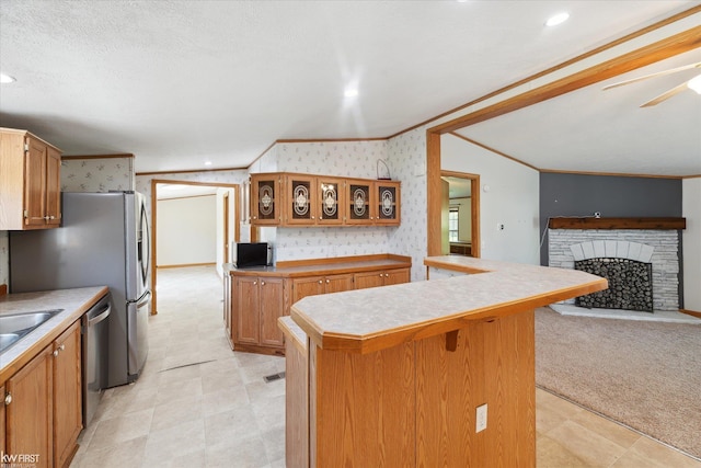 kitchen with crown molding, stainless steel dishwasher, wallpapered walls, a breakfast bar, and a sink