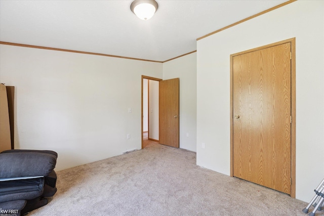 unfurnished bedroom featuring carpet and crown molding