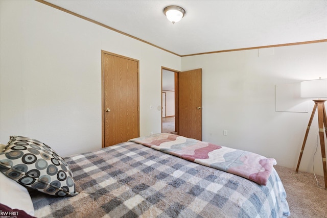 carpeted bedroom with ornamental molding