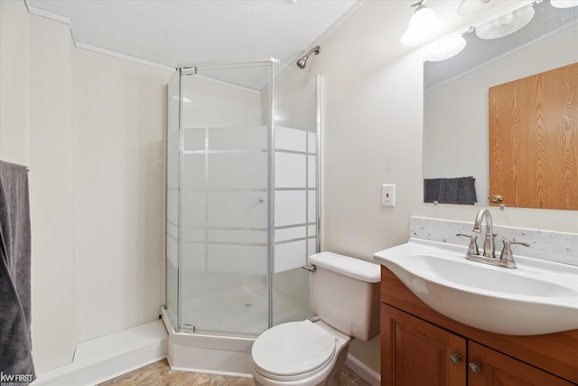 full bath featuring a stall shower, toilet, and vanity