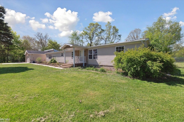 rear view of house featuring a garage and a porch