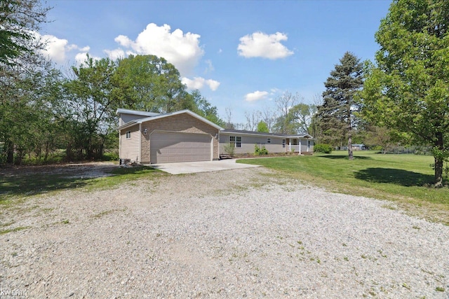 view of front of property with a front yard, driveway, and an attached garage
