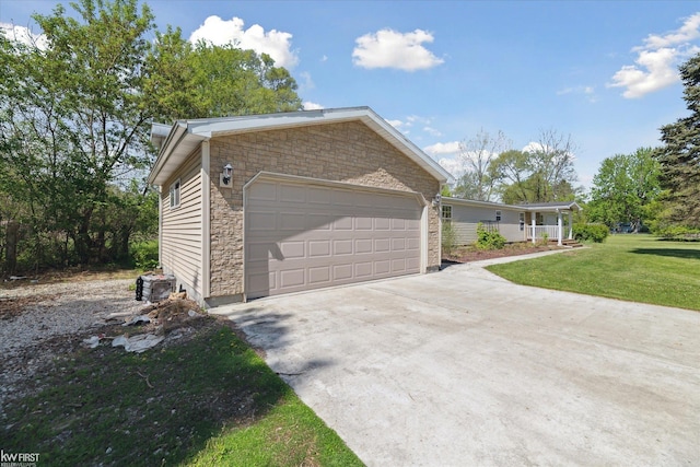 view of front of home with stone siding, concrete driveway, a front lawn, a garage, and cooling unit