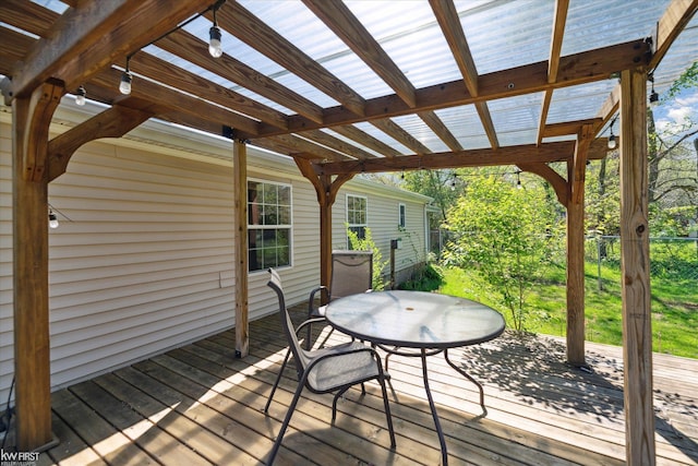 deck featuring fence, outdoor dining area, and a pergola