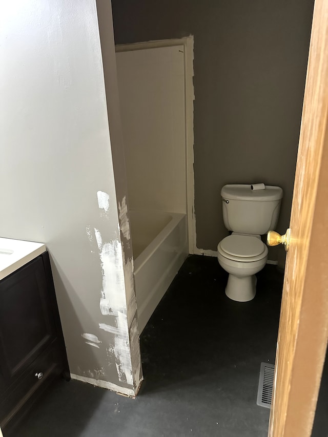 5151 Huntley Dr, Holly, MI 48442 - bathroom with toilet, concrete flooring, a tub to relax in, vanity, and baseboards