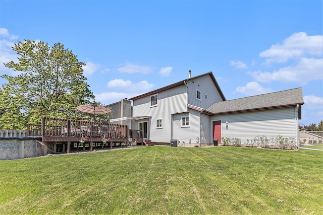 back of property with a wooden deck, a yard, and cooling unit