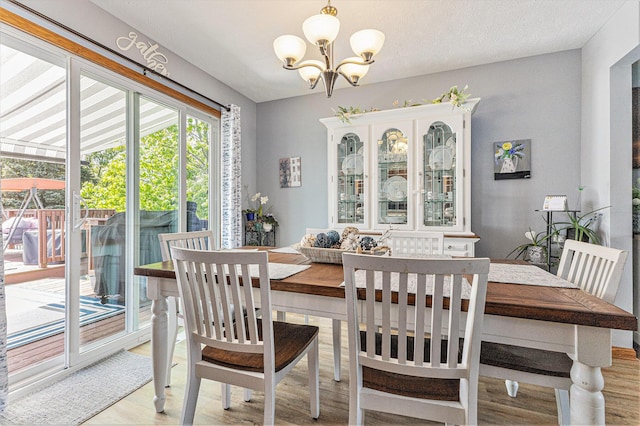 dining space featuring a chandelier and light wood-style flooring