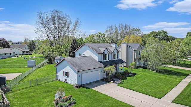 view of front of home featuring driveway, an attached garage, roof with shingles, and a residential view