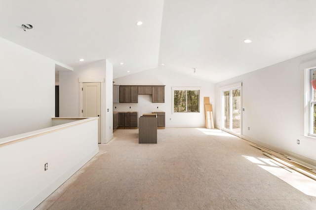 1826 S Barnes Rd, Muskegon, MI 49442 - unfurnished living room with lofted ceiling, healthy amount of natural light, light carpet, and recessed lighting