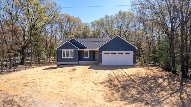 1826 S Barnes Rd, Muskegon, MI 49442 - garage with dirt driveway and a wooded view