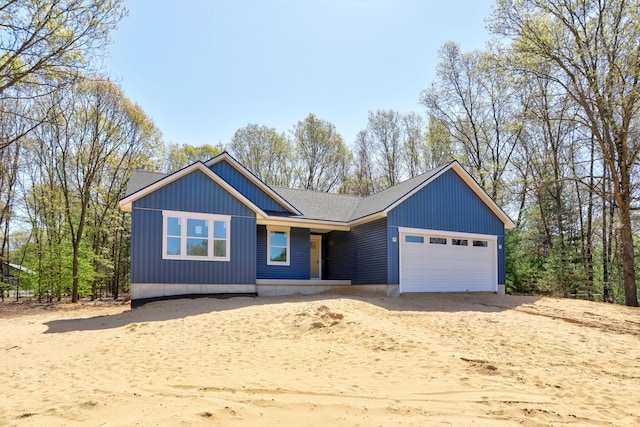 1826 S Barnes Rd, Muskegon, MI 49442 - view of front of house featuring a garage, driveway, and roof with shingles