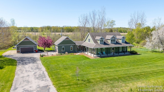 242 Sherman Blvd, Kent City, MI 49330 - view of front of property with covered porch, a front yard, and a detached garage