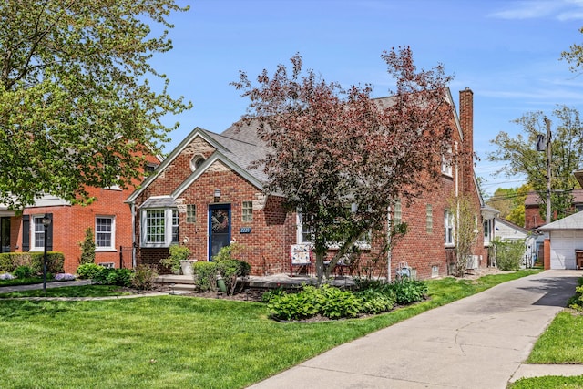 2220 Stanhope St, Grosse Pointe Woods, MI 48236 - view of front of home featuring brick siding, a front yard, a chimney, and a detached garage
