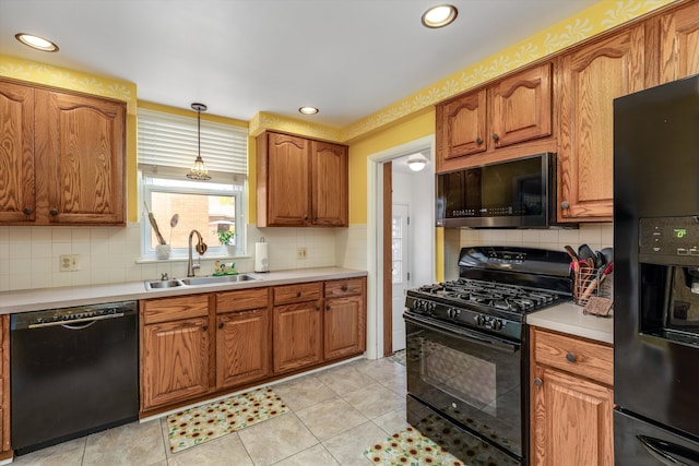 2220 Stanhope St, Grosse Pointe Woods, MI 48236 - kitchen featuring black appliances, a sink, brown cabinetry, tasteful backsplash, and pendant lighting