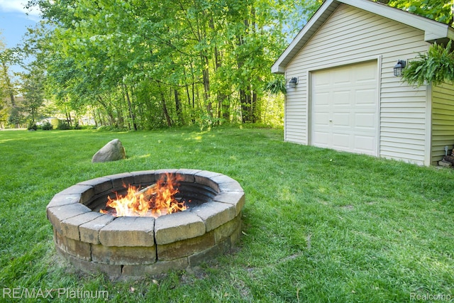 3873 Hartland Hills Dr, Hartland, MI 48353 - view of green lawn featuring an outdoor fire pit and an outbuilding