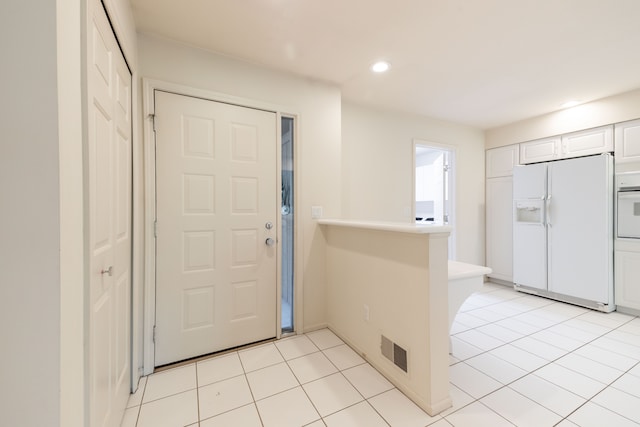 foyer entrance featuring recessed lighting and light tile patterned floors