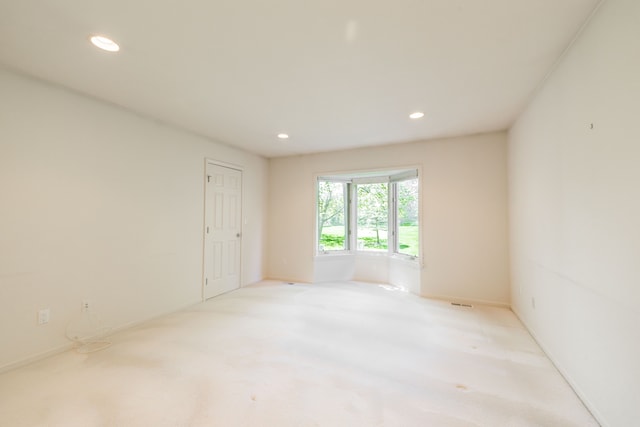 spare room with recessed lighting, carpet floors, and baseboards