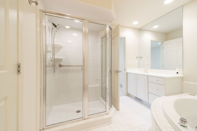 full bathroom featuring a stall shower, a bath, vanity, tile patterned floors, and recessed lighting