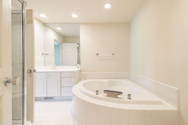 bathroom featuring a bath, vanity, a stall shower, tile patterned flooring, and recessed lighting