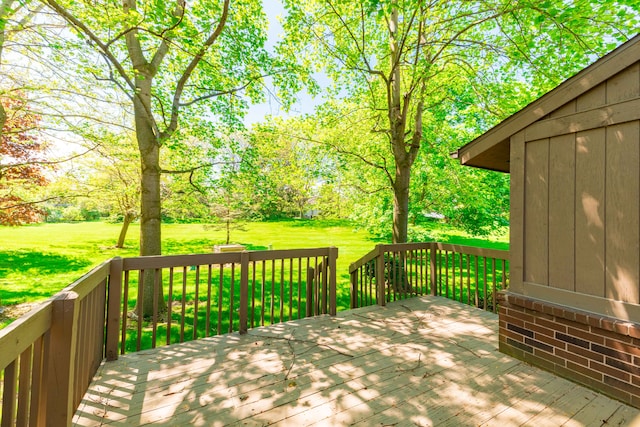 wooden terrace featuring a lawn