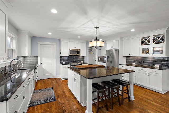 1836 Marywood Dr, Royal Oak, MI 48073 - kitchen featuring appliances with stainless steel finishes, a sink, backsplash, a center island, and white cabinetry