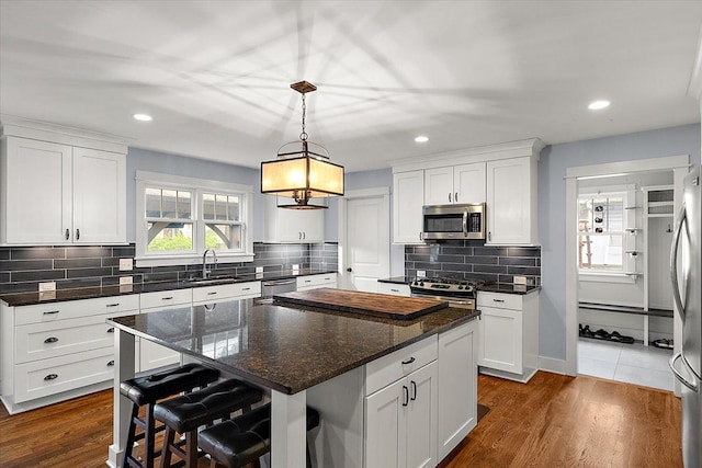 1836 Marywood Dr, Royal Oak, MI 48073 - kitchen featuring appliances with stainless steel finishes, a sink, a center island, white cabinetry, and recessed lighting