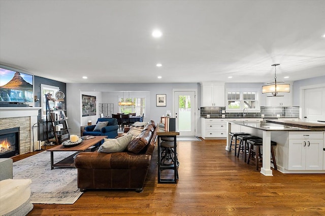 1836 Marywood Dr, Royal Oak, MI 48073 - living area featuring a chandelier, dark wood finished floors, recessed lighting, and a stone fireplace
