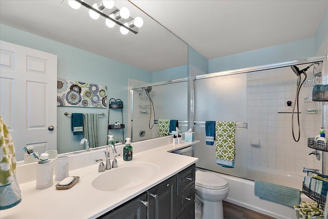 143 Campau Cir NW Unit 1616, Grand Rapids, MI 49503 - bathroom with vanity, toilet, wood finished floors, and enclosed tub / shower combo