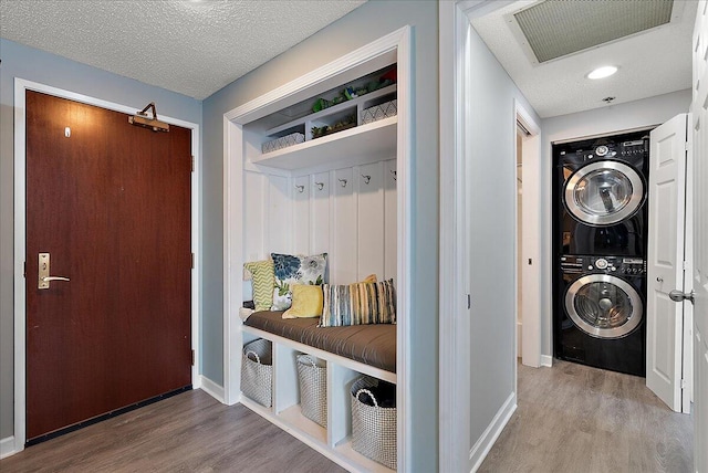 143 Campau Cir NW Unit 1616, Grand Rapids, MI 49503 - mudroom with estacked washer and dryer, wood finished floors, baseboards, and a textured ceiling